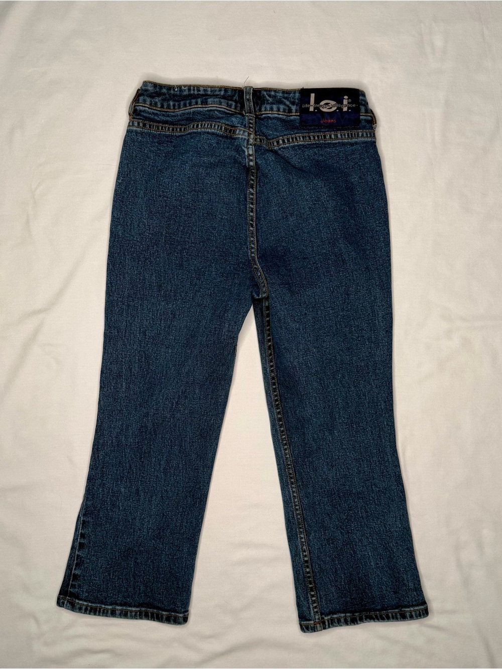 Vintage mid-wash blue denim l.e.i. bootcut jeans for girls.